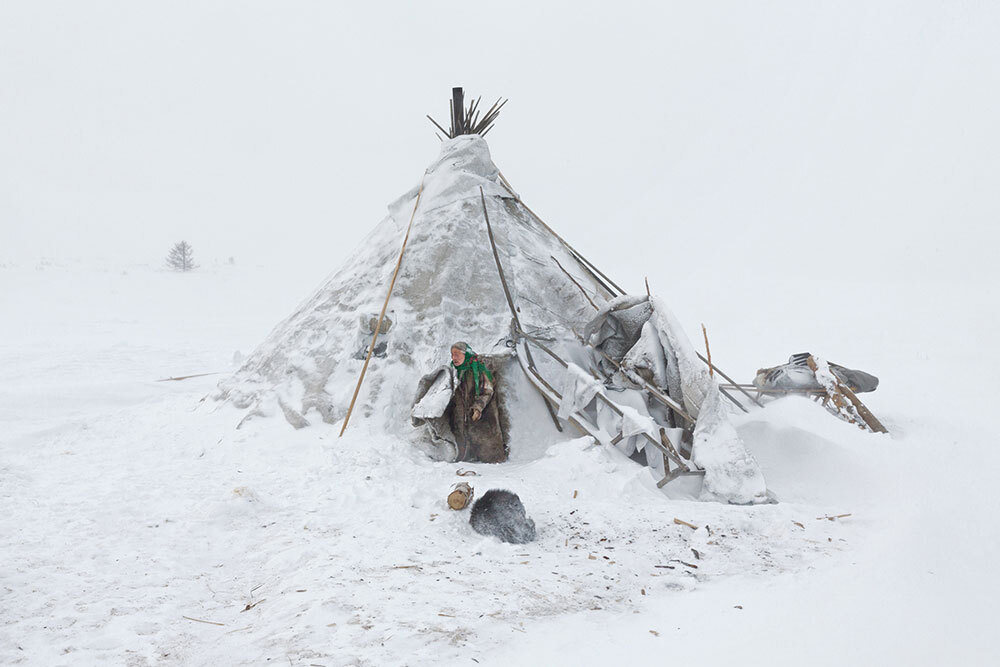 A picture of a teepee-like tent in the snow