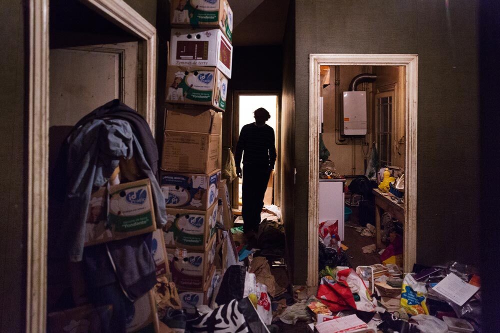 A man with a hoarding disorder is seen in his garbage-filled apartment, where he lives alone.