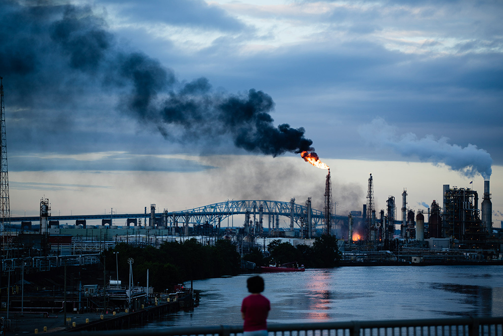 Flames and smoke billow from the Philadelphia Energy Solutions Refining Complex in Philadelphia in 2019. Scientists are beginning to understand how breathing air filled with pollution impairs the immune system’s ability to regulate inflammation.