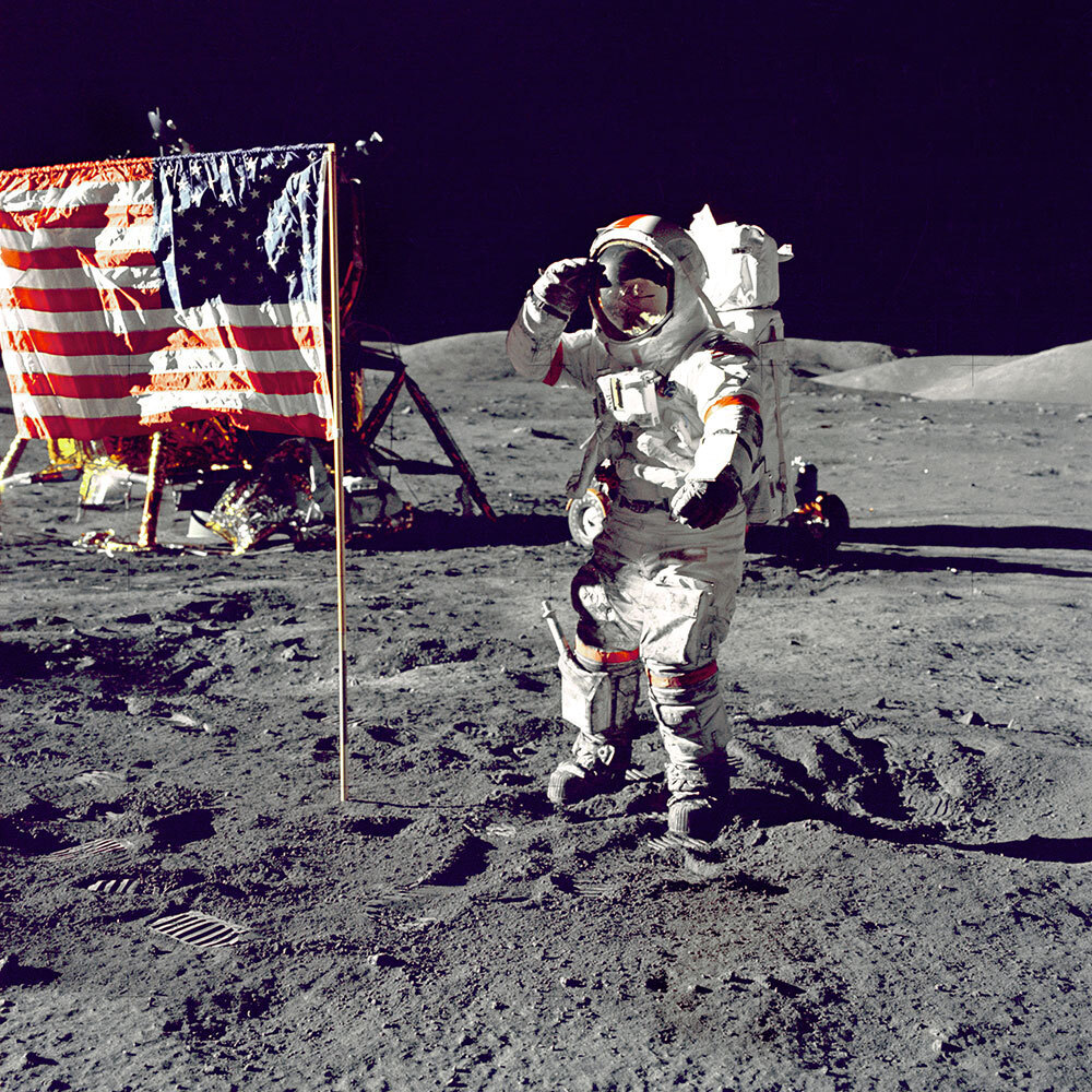 A picture of Apollo 17 commander Eugene A. Cernan standing by the American flag during his second space walk on the moon.