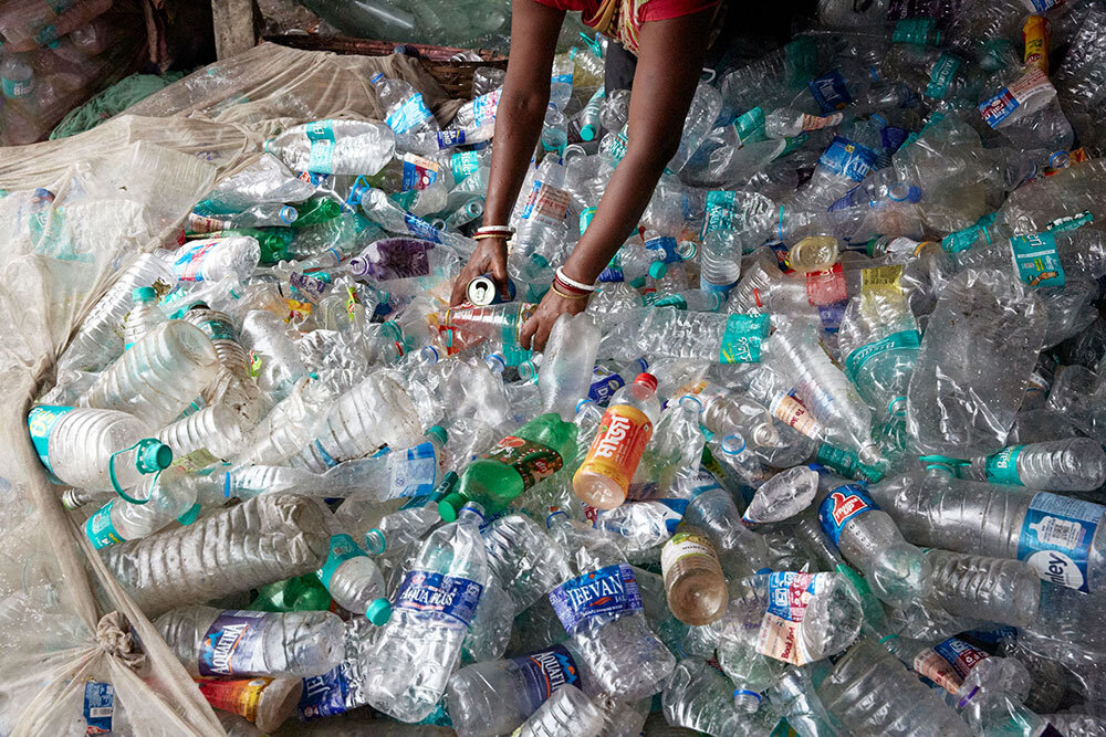 waste pickers go through plastic bottles