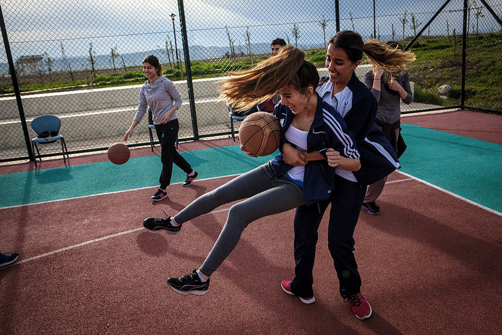 Women playing basketball