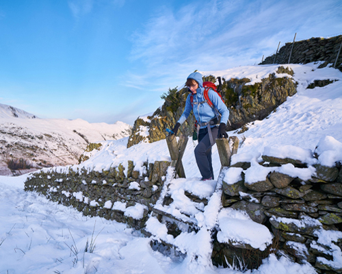 A hiker walking on snow