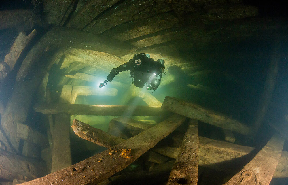 Johann Rönnby, shown here diving amid the stunningly preserved wreckage, discovered the Mars site with his team more than a decade ago.