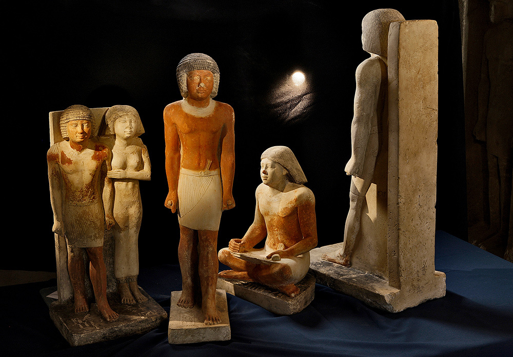 Various statues in positions standing and sitting.