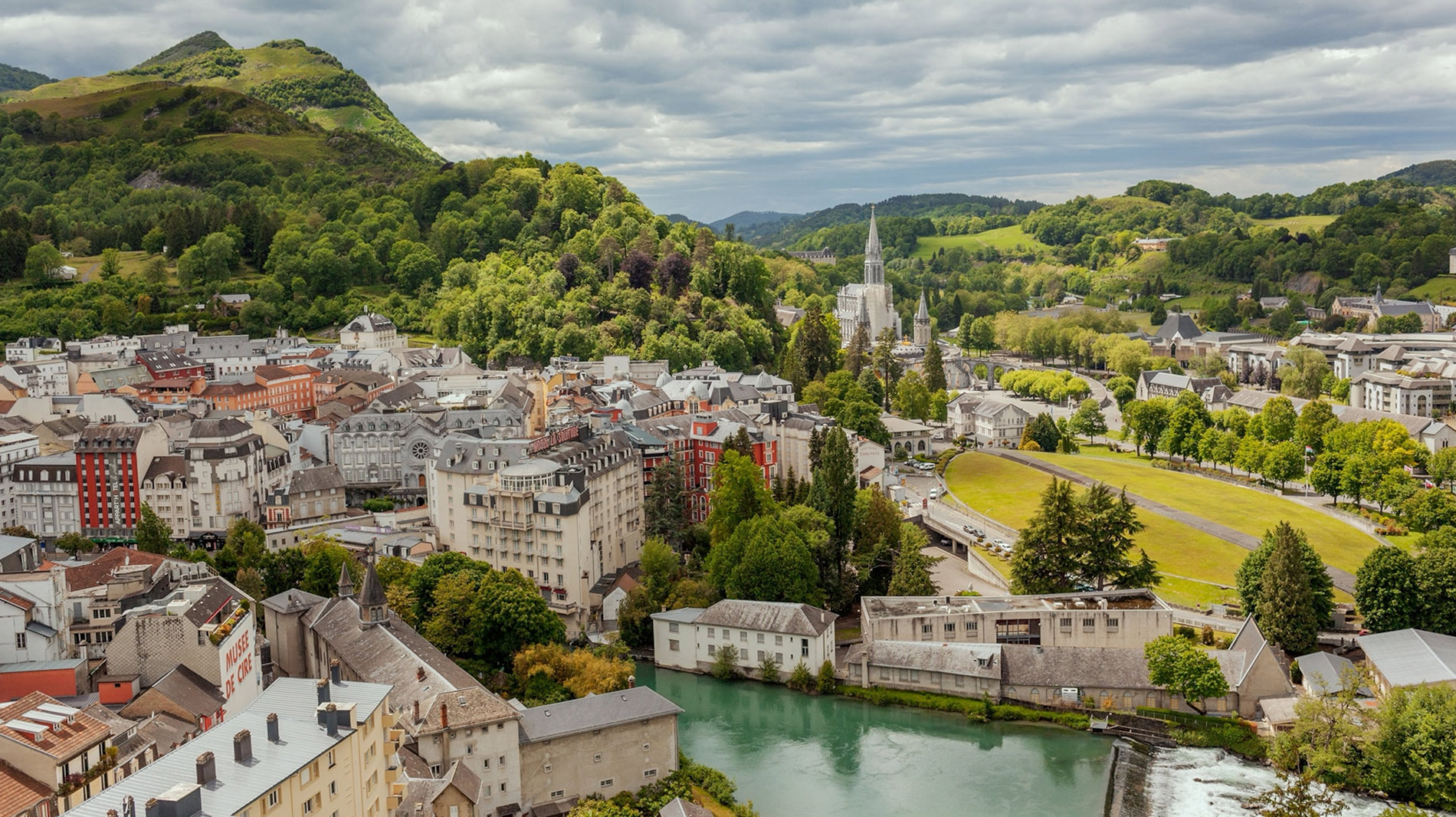 This aerial view taken in May 2021 shows Lourdes from the medieval castle. The sanctuary is visible in the distance.