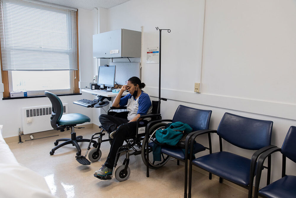 A woman sits in a doctor's office room