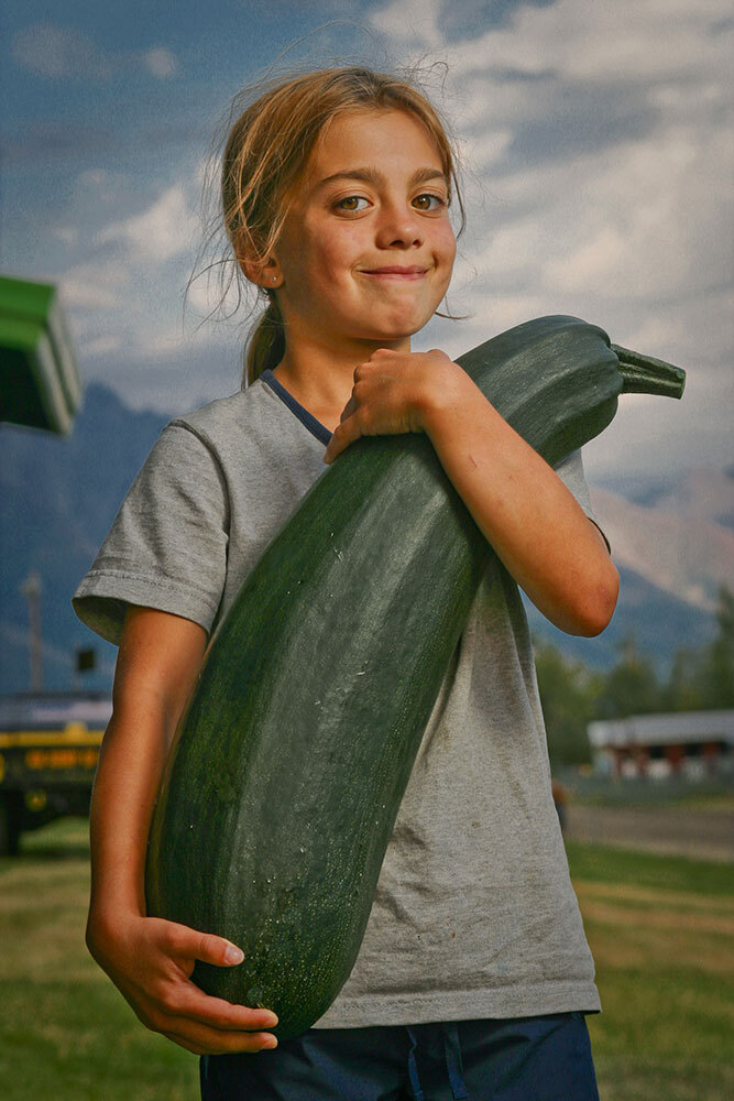 Loren Olsen holds a jumbo zucchini during one of the annual Alaska State Fair competitions.