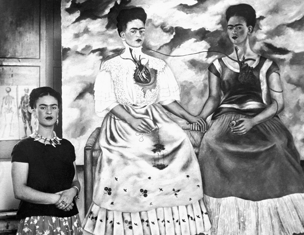 Frida Kahlo with her self portraits