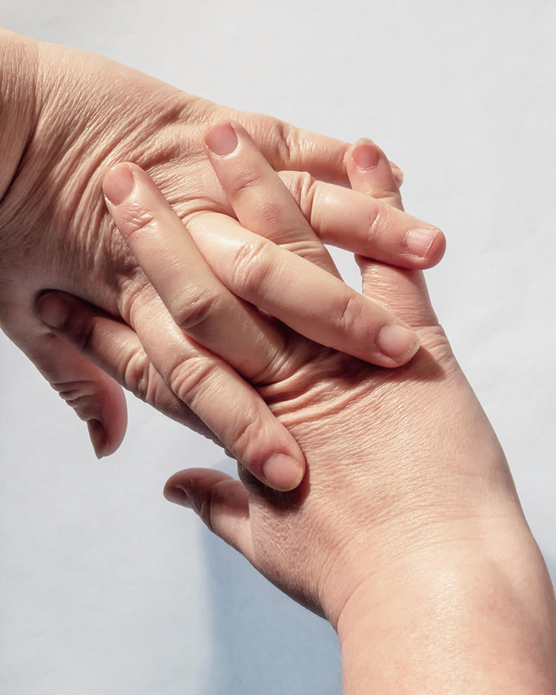 A pair of outstretched hands with interlocking fingers bent back to crack the knuckles