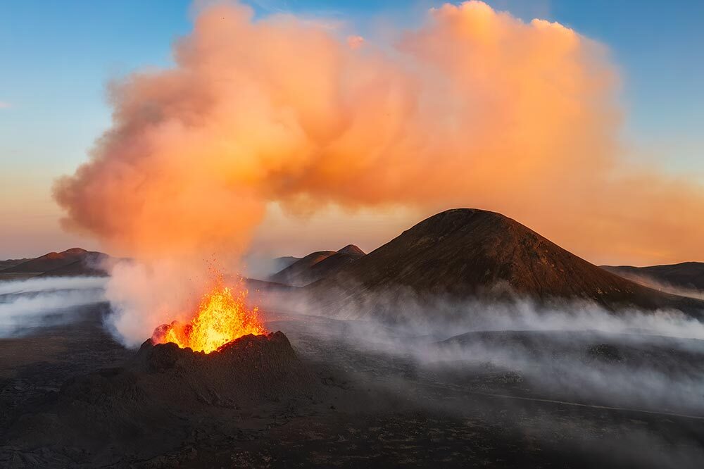 Photographed on July 11, 2023—the Fagradalsfjall Volcano's gas cloud stretches over the Litli-Hrútur mountain and is illuminated at sunset.