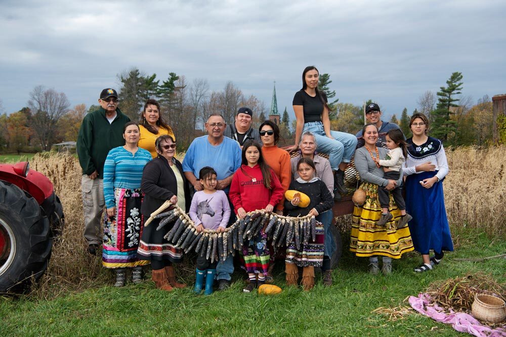 Standing in their field, members of the Onkwe community garden in Akwesasne, New York, display traditional varieties of corn, squashes, and beans they are reviving. Onkwe is one of about a hundred such projects in Haudenosaunee territory.