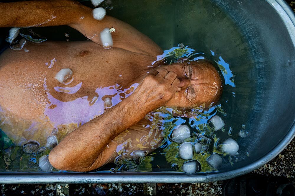 A man takes an ice bath in a tub