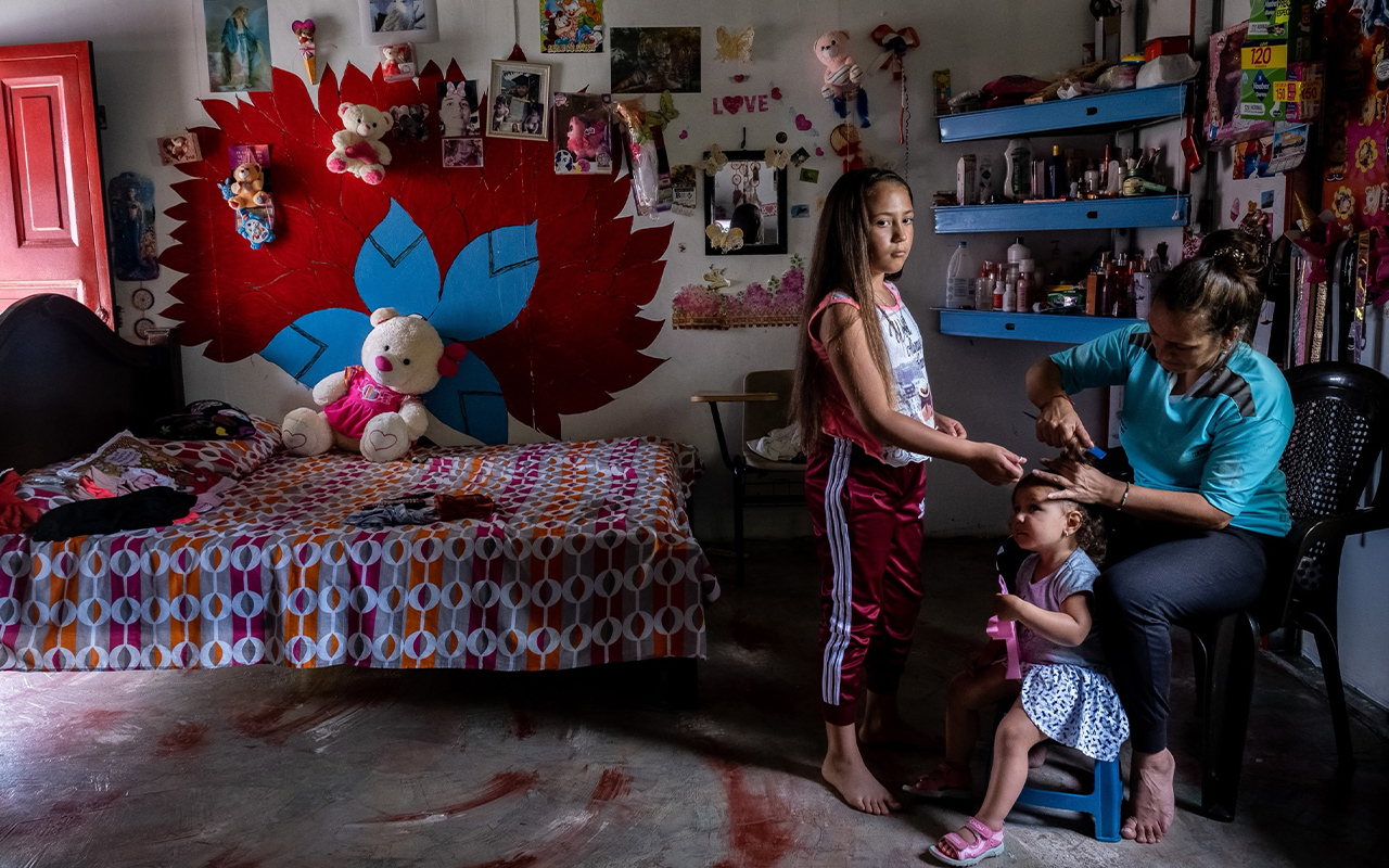 At the Anorí demobilization camp in Colombia, Luz Arelis Duque, 32, looks after her eight-year-old daughter María Isabel and her three-year-old neighbor Camila.