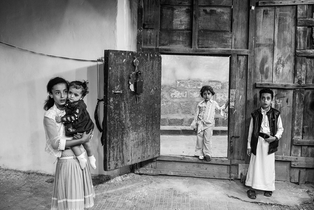 Kids stand in a doorway