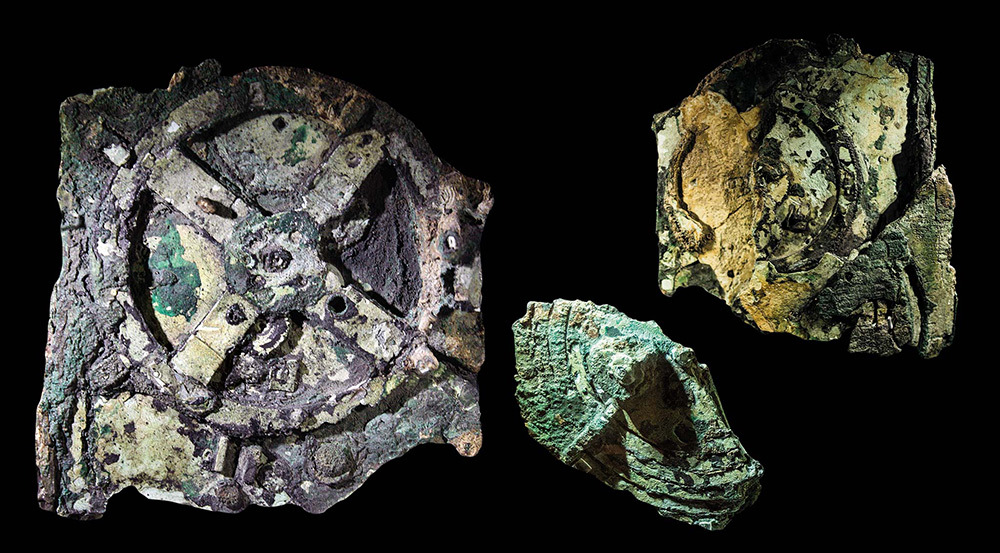 Fragments of the Antikythera Mechanism on a black background