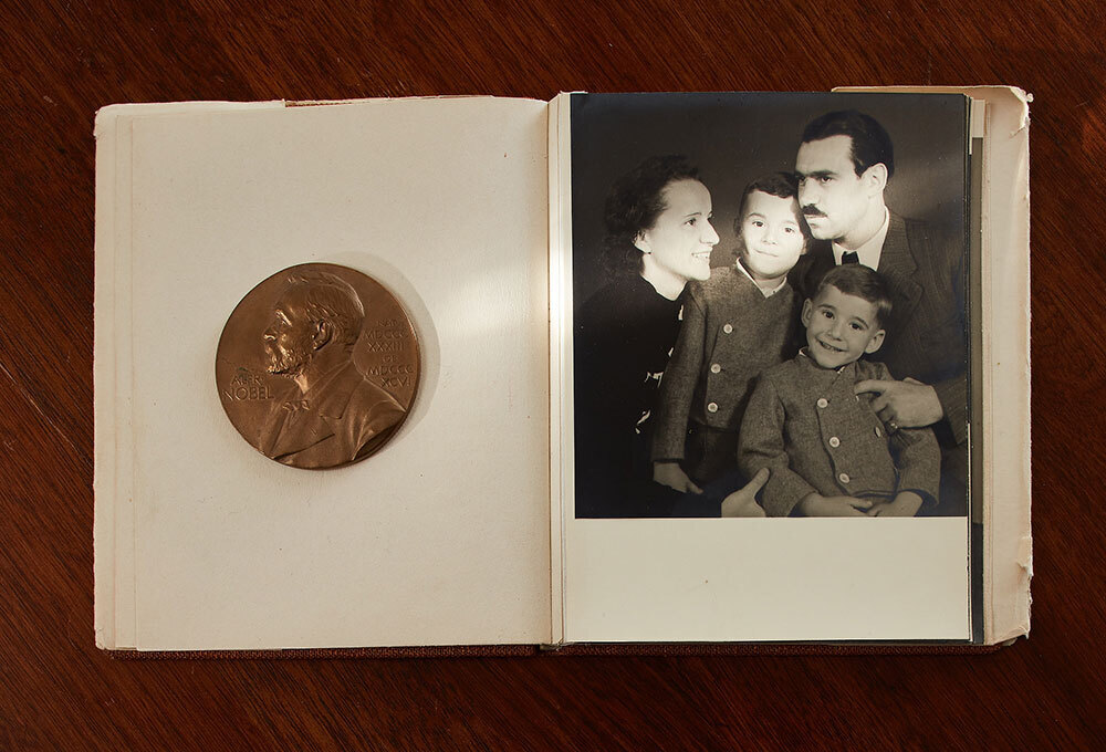 A book shows a photo of a six-year-old Arno Penzias between his parents and a younger brother