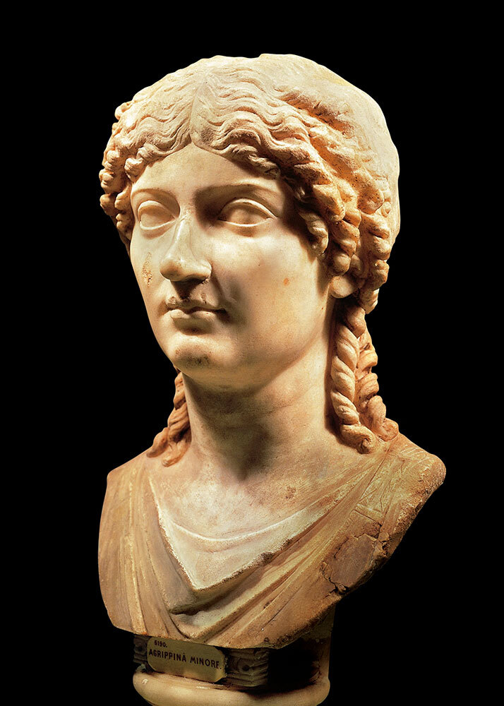 a marble bust of a woman against a black background