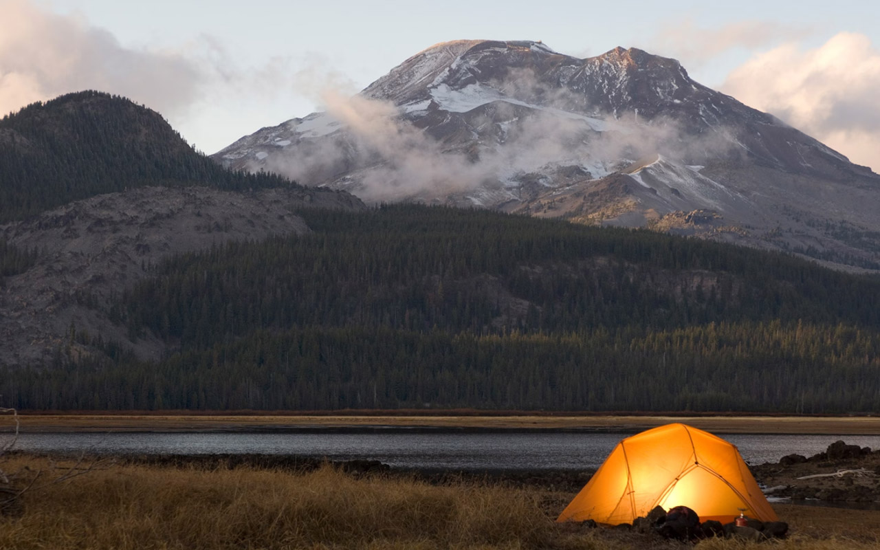 Campers set up their tent at the base of the Cascade Mountains in Oregon.