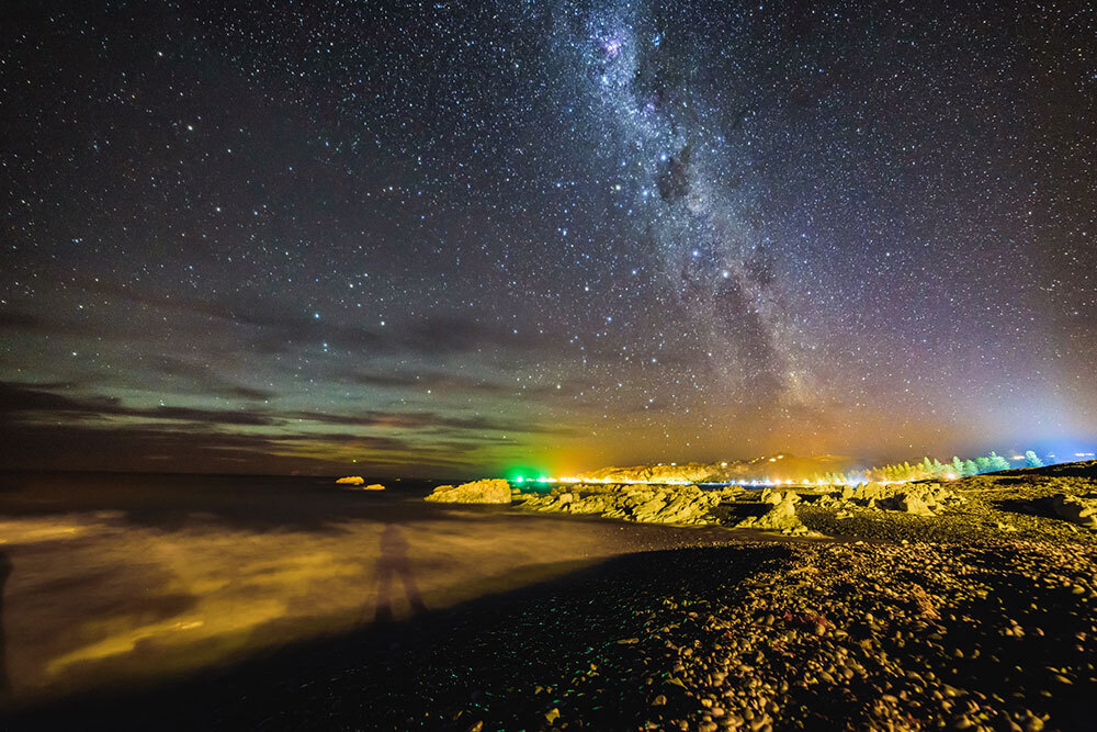 The Milky Way appears over a beach