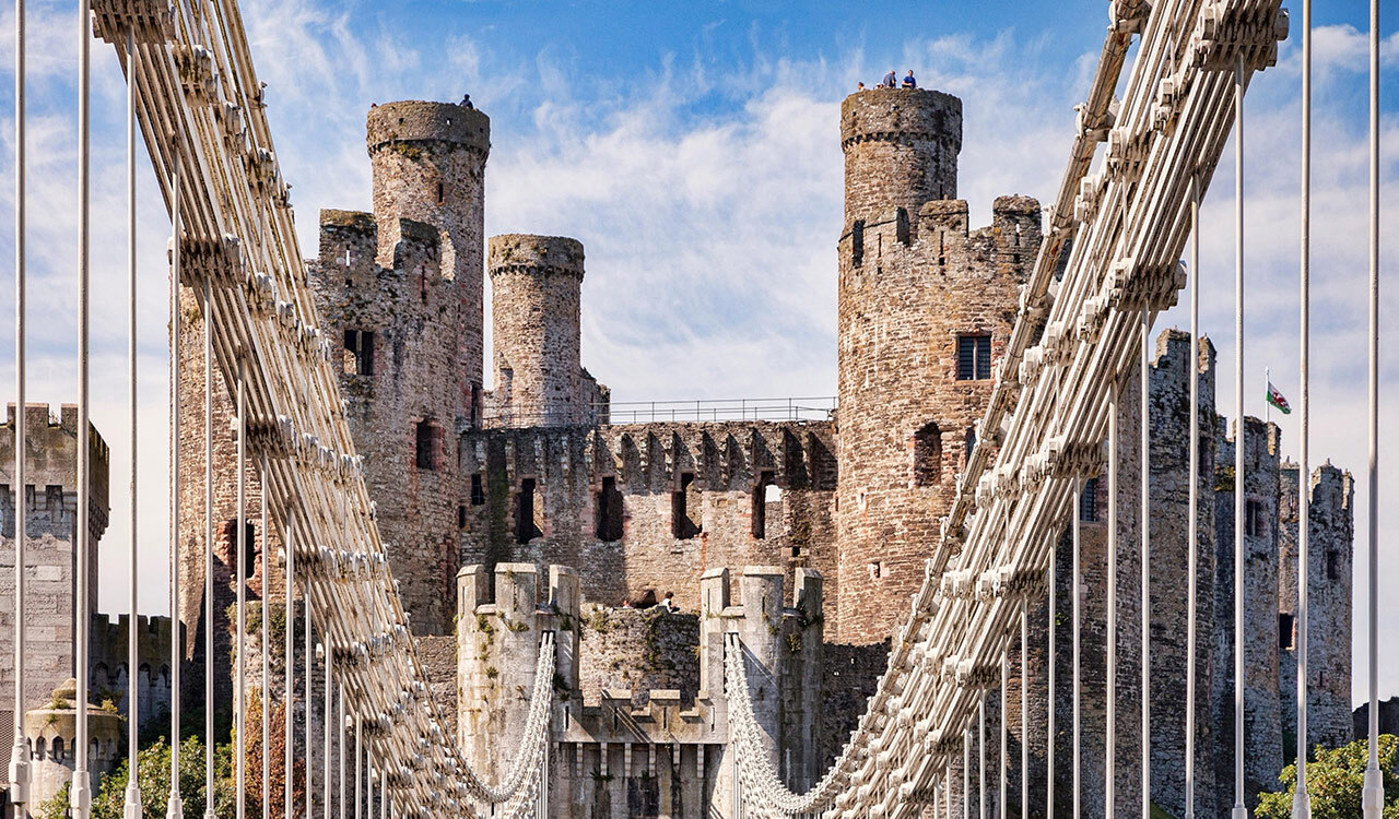 Thomas Telford’s 1826 suspension bridge is one of the world’s first and leads into the town of Conwy, in Wales, home of Conwy Castle.