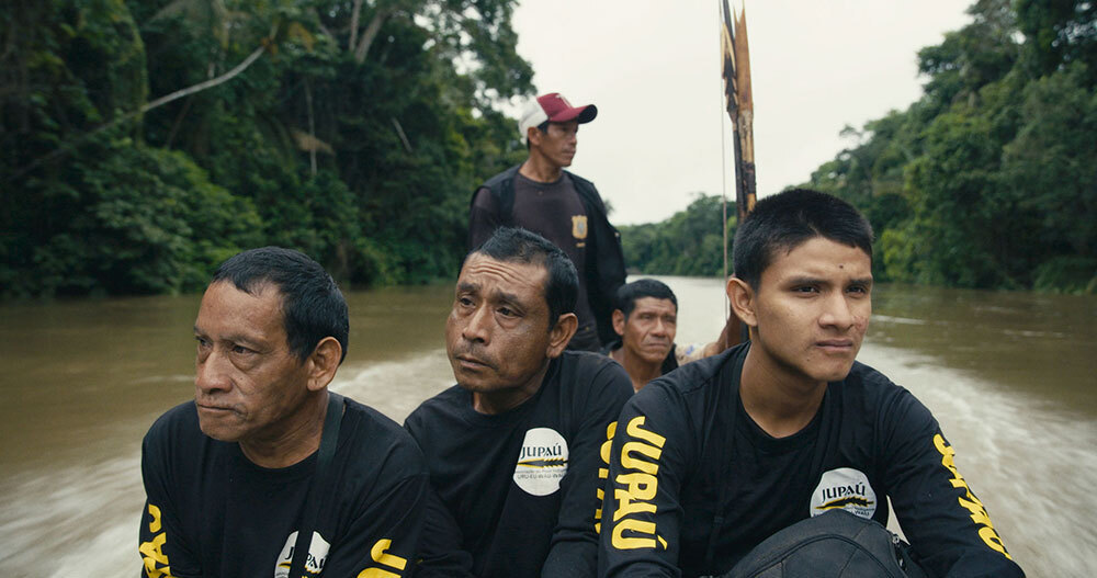 A picture of a group of men in a boat in a river.