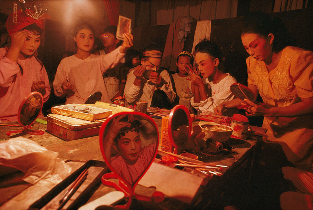 Actors put on make up before a performance