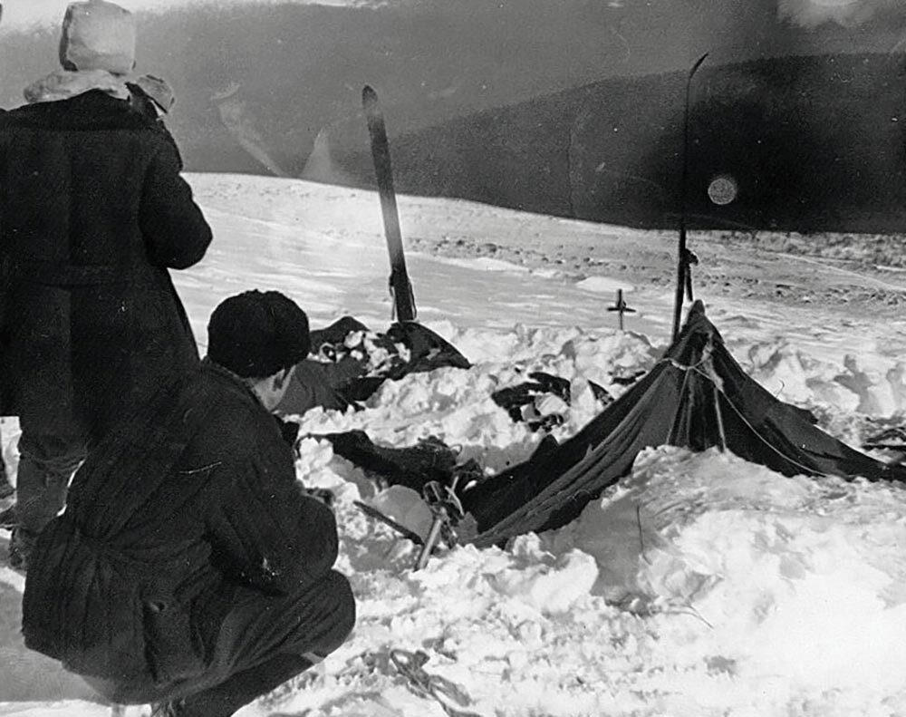 Investigators examine the tent belonging to the hikers/