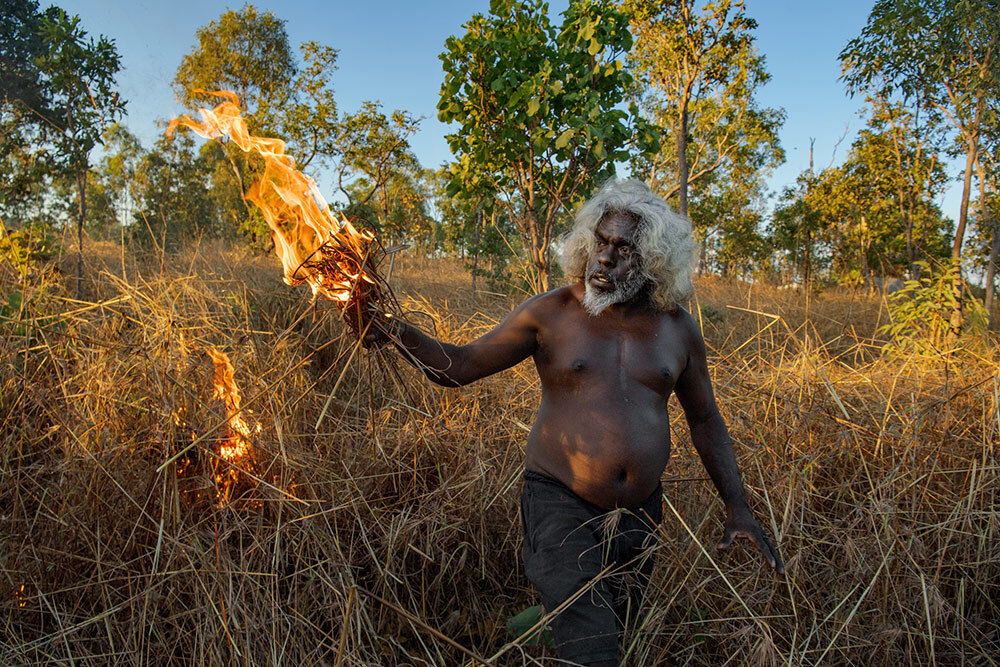 A man starts a low-intensity blaze to protect his community