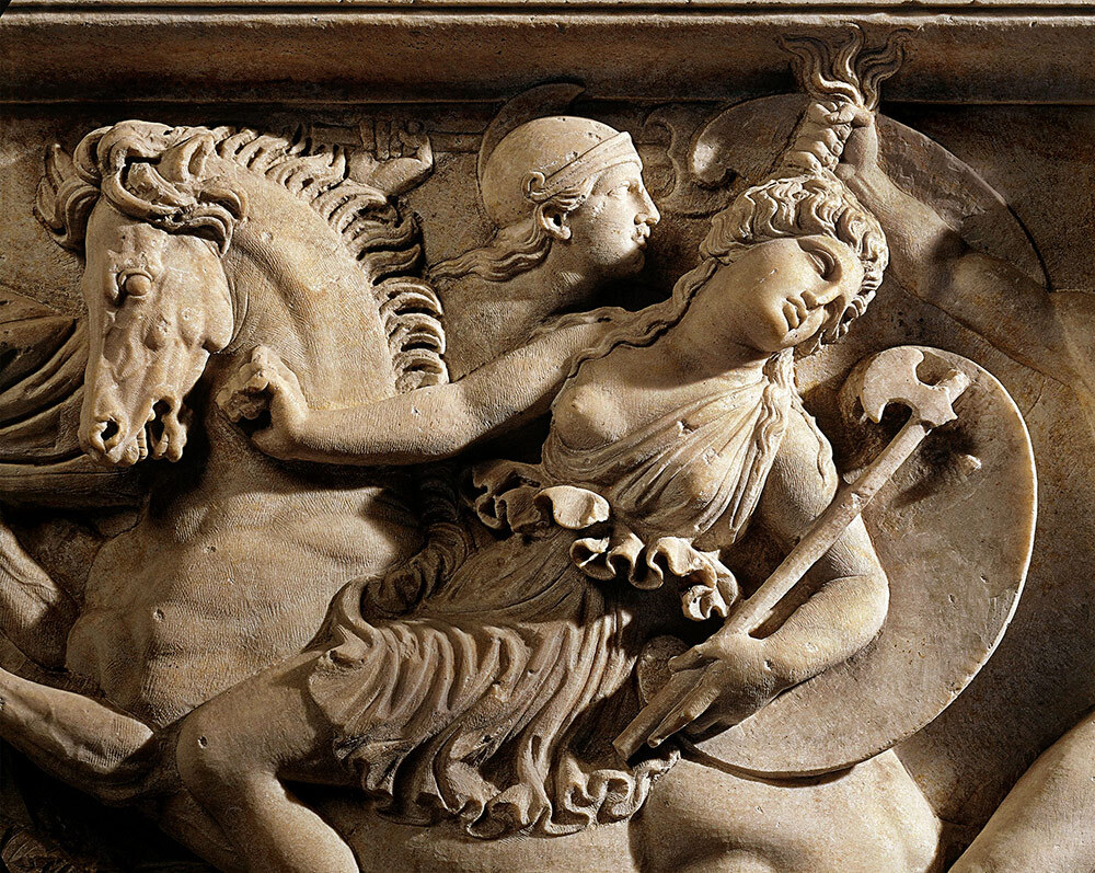 A marble carving of a woman fighting on horseback