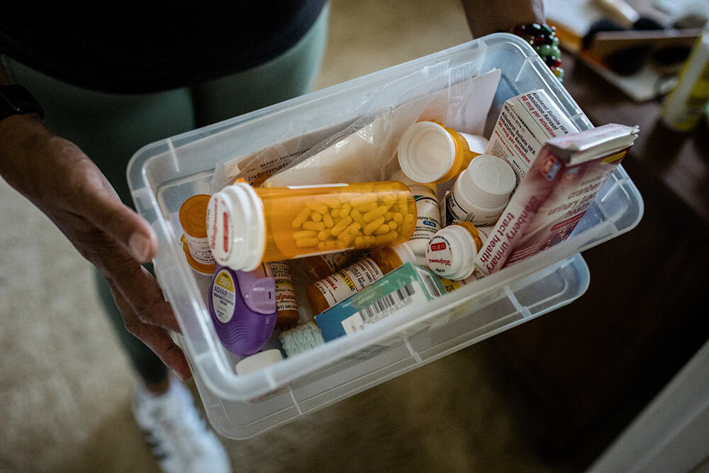 Leslie Hawkins displays a box of her mother's medications at their Takoma Park, Md., home on June 4, 2021.