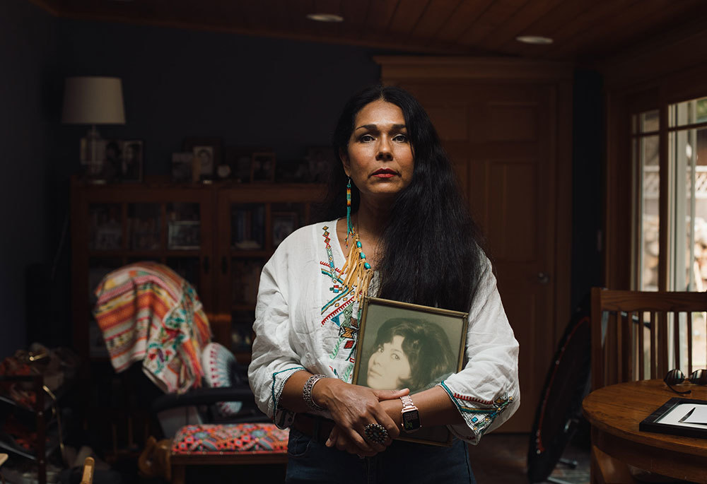 A picture of a woman holding a portrait of a woman