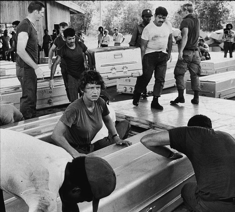 Members of a US military team prepare aluminum coffins for shipment to the United States