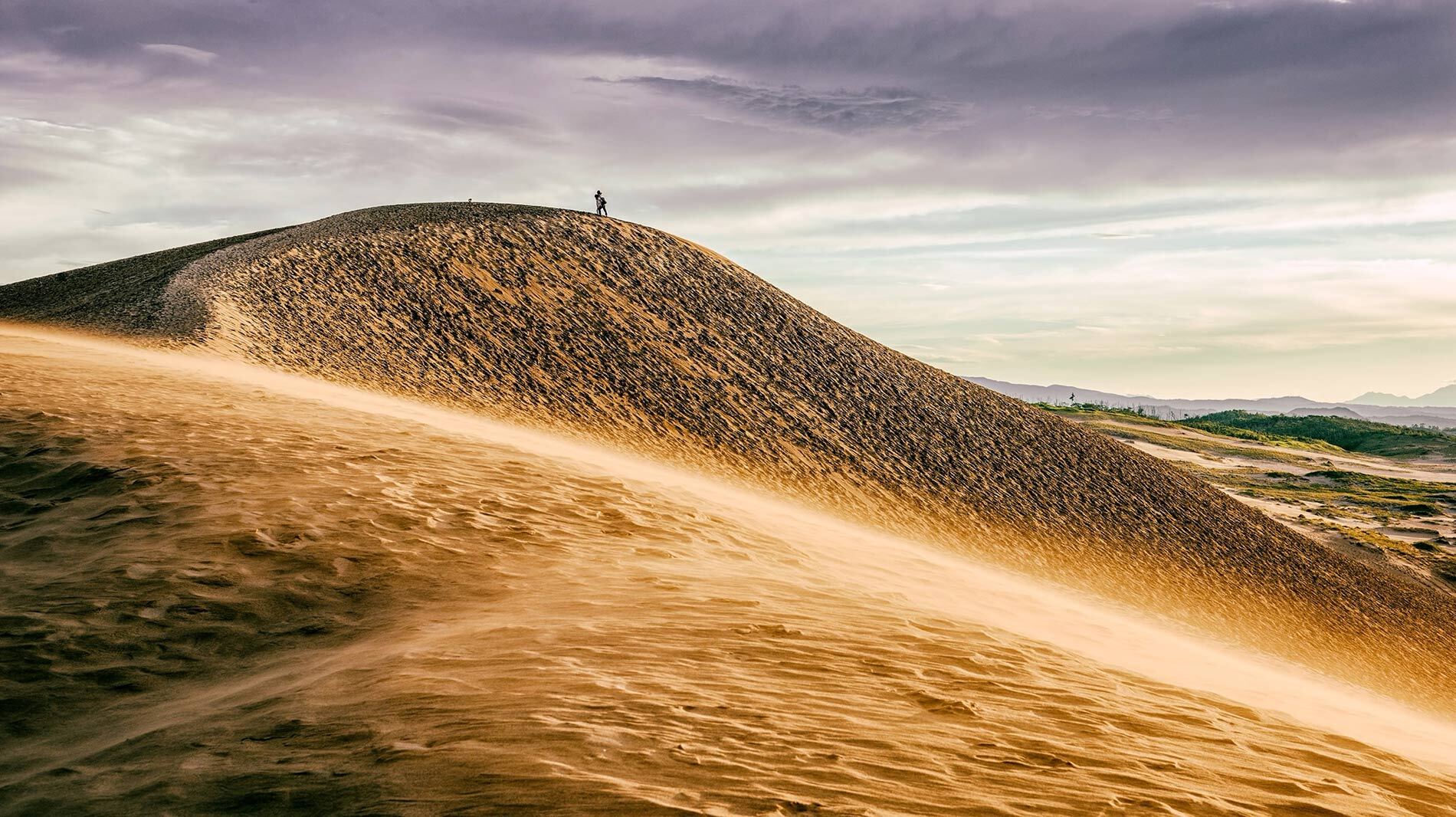 Sea winds sweep over Tottori's rolling sand dunes along Japan's coast. The area has shrunk in recent years due to changing sea currents and the encroachment of plants.