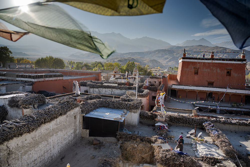 A picture of rooftops and a prayer flag