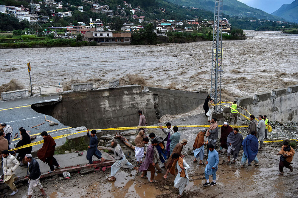 A raging river washes away a road