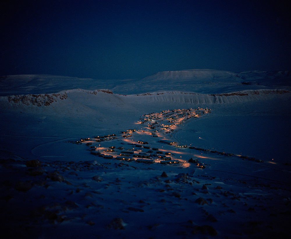 In December, the village of Arctic Bay, Nunavut glows through the winter darkness