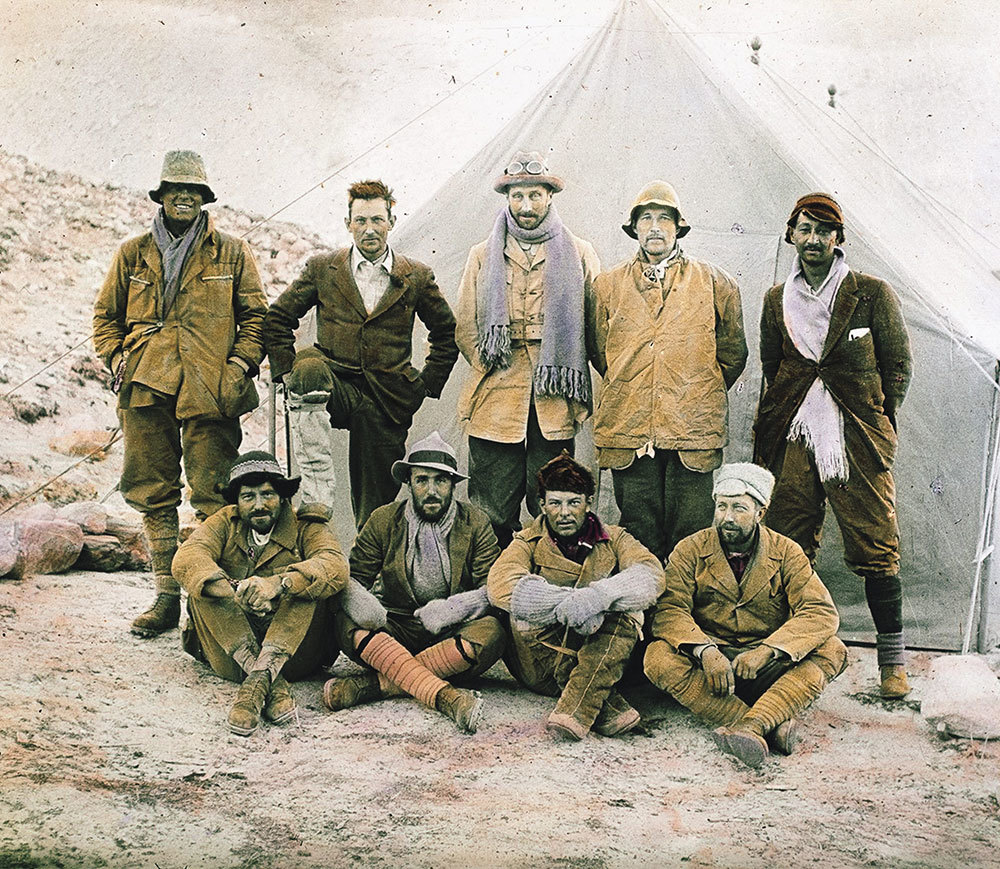 A picture of men lined up in front of a tent