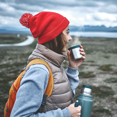 A traveler having a hot beverage