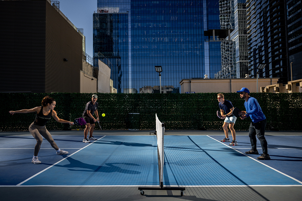 Pickleball players on a rooftop pickleball court in downtown Austin.