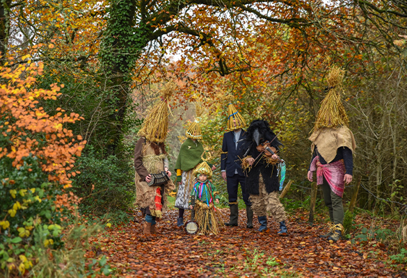 In Leitrim, Ireland, a group of mummers dressed in straw costumes prepares to perform for neighbors in the run-up to Christmas.