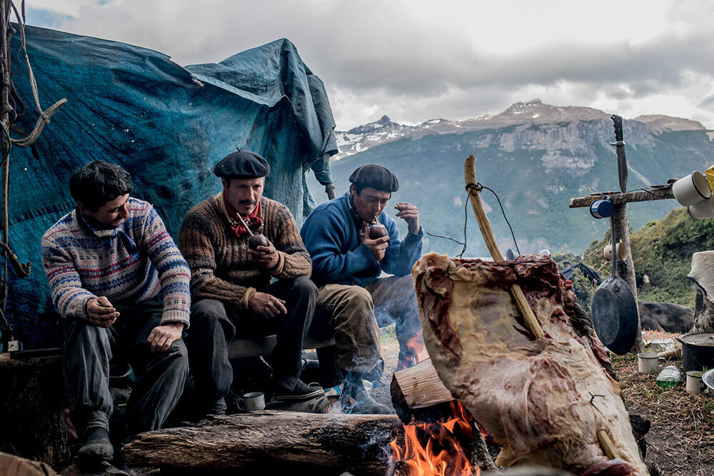 cowbows sitting around a fire drinking yerba mate