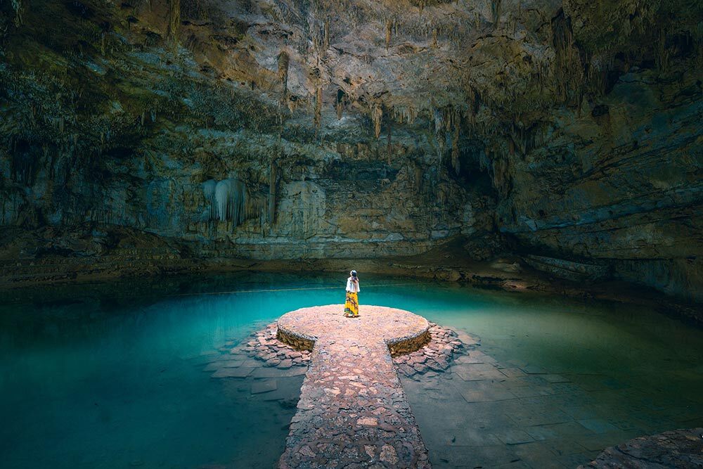 Woman alone in a cenote, Mexico