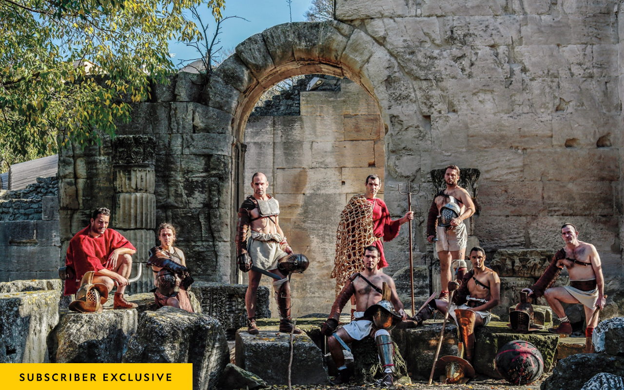 Gladiator reenactors pose amid Roman-era ruins in Arles, France. The equipment they use is based on archaeological finds.