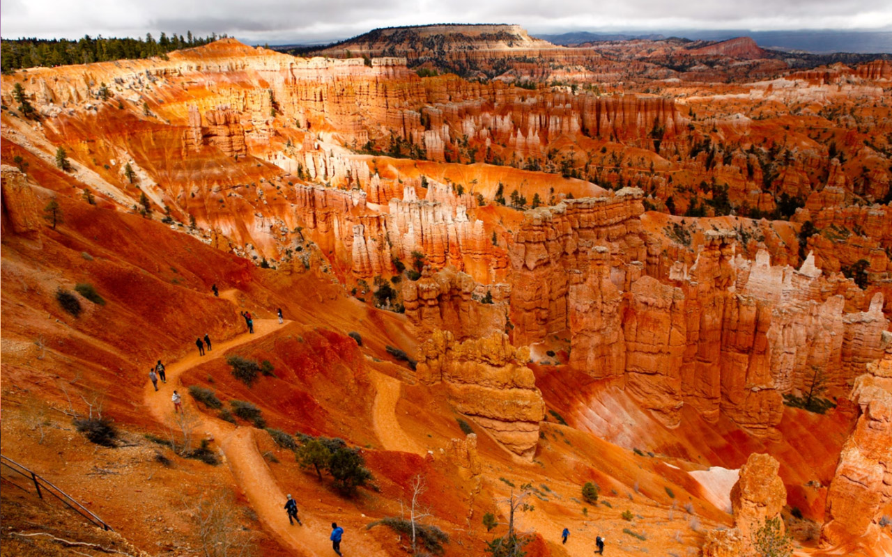 Visitors hike amid the rocks and hoodoo formations of Sunset Point in Bryce Canyon National Park.