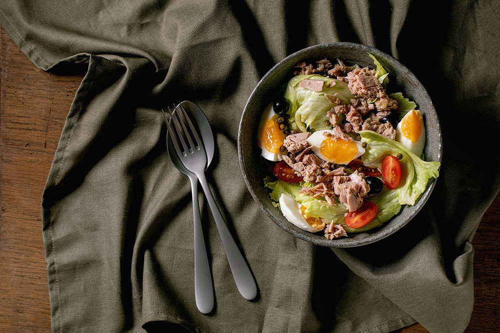A picture of a salad with eggs and tomatoes