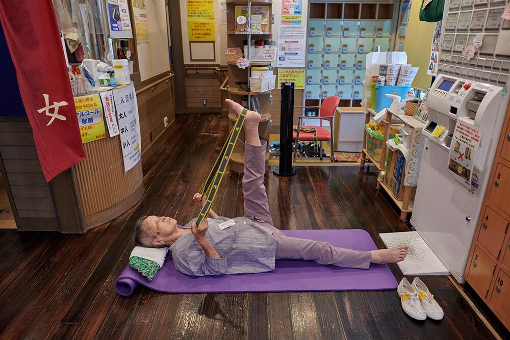 Nanae Takaishi (99) doing exercises in the dressing room of “Shinseiyu”, a bathhouse in Shinagawa ward in Tokyo. The bathhouse was opened in 1952 as a neighborhood public bath for local residents.