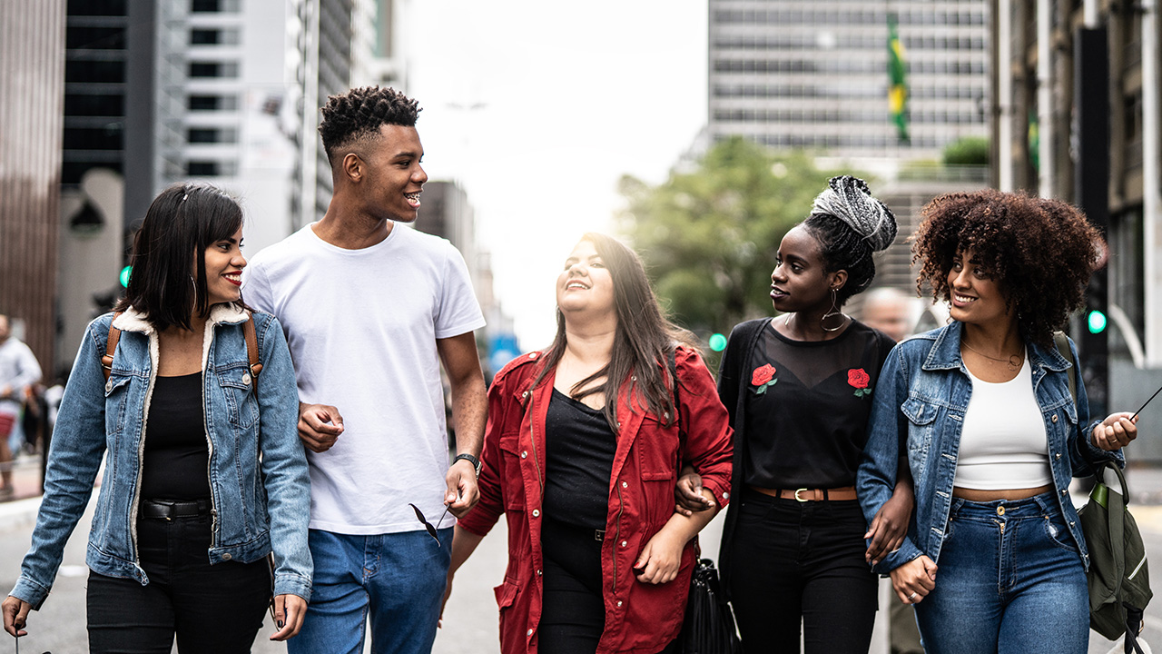 A photo of five people walking