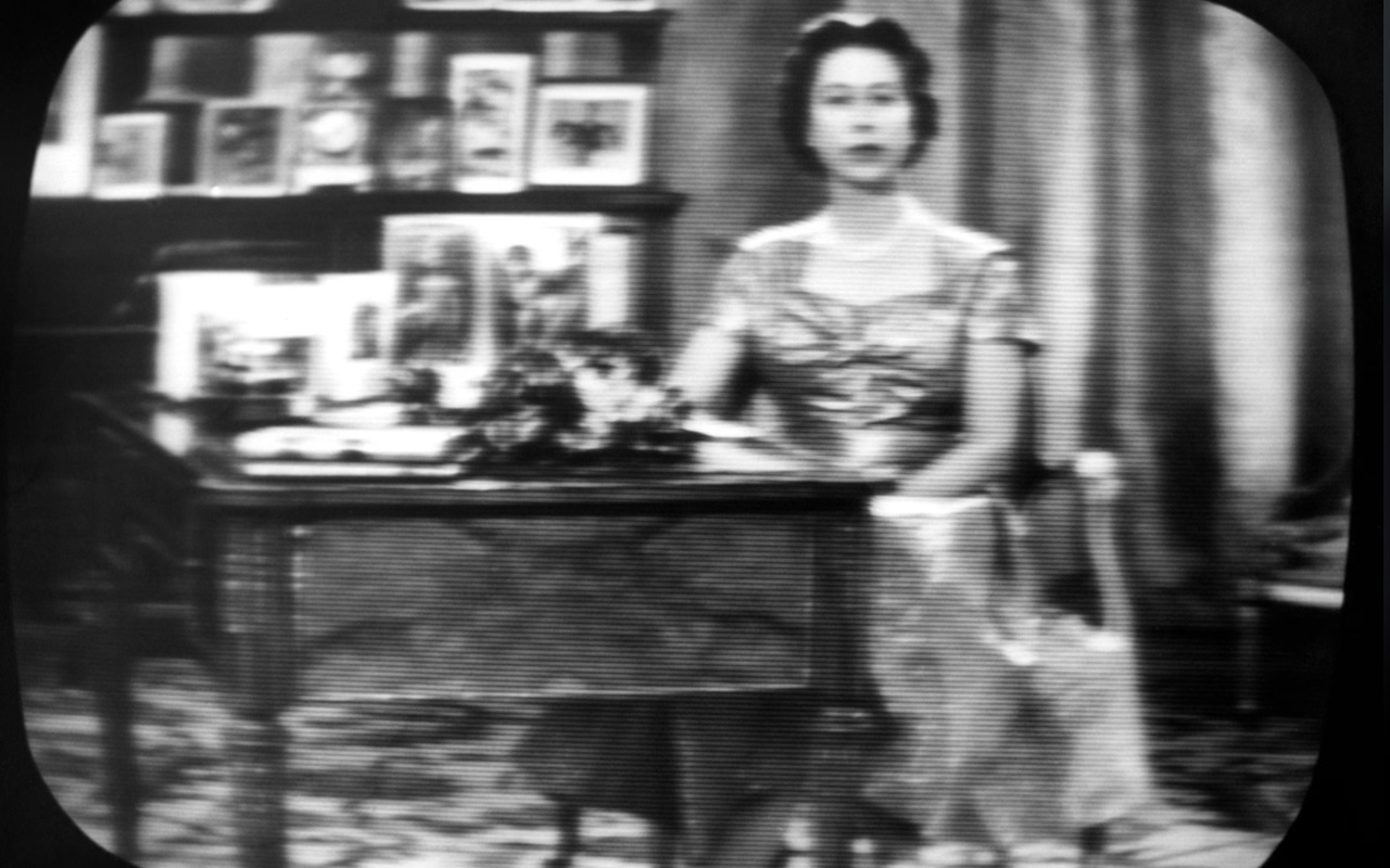 Queen Elizabeth II seen on a television screen as she concludes her annual Christmas Day broadcast on December 25, 1957.