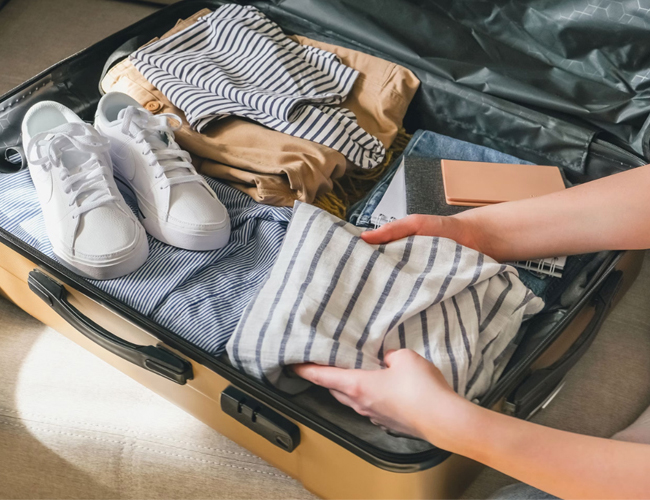 A person packing for a trip.